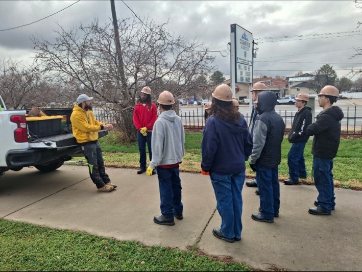 Hampton talking with young people near his work truck before their outdoor activity